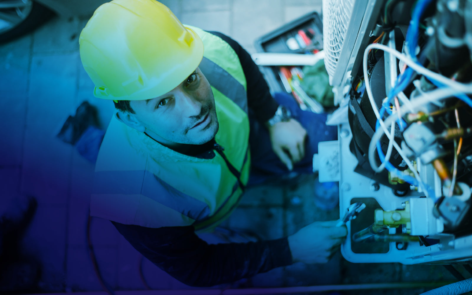 Electrician repairing a control panel in a commercial facility.
