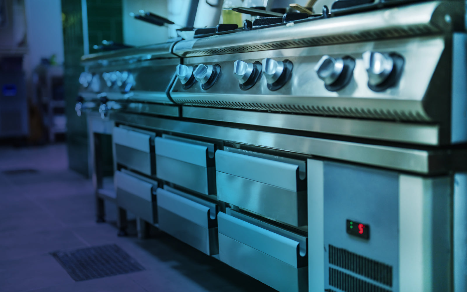 Equipment installation in a commercial kitchen or workspace.