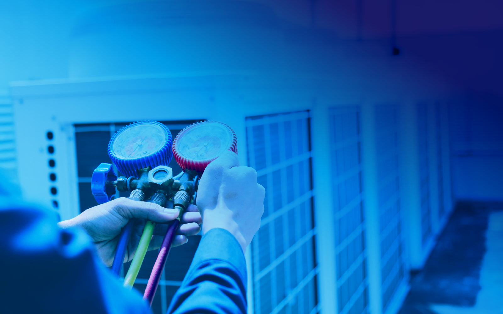 HVAC specialist servicing commercial rooftop air conditioning units.