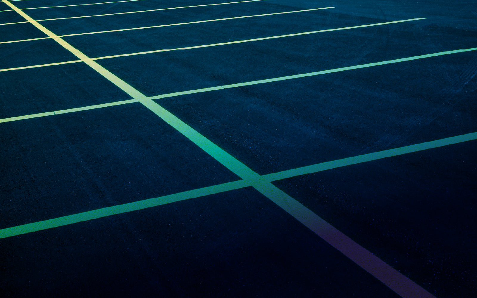 Freshly panited parking lot lines representing parking lot upgrades by Tune Facility Services for commercial properties.